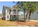 Charming two-story home with a front porch, swing, well-manicured lawn, and attached garage at 1532 Roustabout Way, Charleston, SC 29414