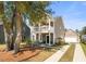 Charming two-story home with a front porch, swing, well-manicured lawn, and attached garage at 1532 Roustabout Way, Charleston, SC 29414