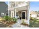Welcoming front porch features a comfortable swing and manicured landscaping at 1532 Roustabout Way, Charleston, SC 29414