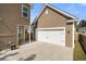 Attached garage with a wide driveway and a view of the house, offering convenience and curb appeal at 1532 Roustabout Way, Charleston, SC 29414