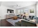 Cozy living room with plenty of natural light, a ceiling fan and stylish furniture at 1532 Roustabout Way, Charleston, SC 29414
