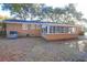 View of the backyard with brick house and lots of windows, plus an AC unit at 1595 Dickens St, Charleston, SC 29407