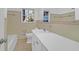 Bathroom with long vanity mirror, tiled walls and floor at 1595 Dickens St, Charleston, SC 29407