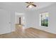 A bright bedroom featuring neutral paint, hardwood floors, and views from two windows at 1595 Dickens St, Charleston, SC 29407