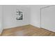 This bedroom has a window letting in light and a closet with sliding doors and wood floor at 1595 Dickens St, Charleston, SC 29407