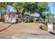 Brick home with covered porch, mature trees, and attached two-car garage at 1595 Dickens St, Charleston, SC 29407