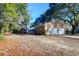 Brick home featuring an attached two-car garage and a spacious backyard at 1595 Dickens St, Charleston, SC 29407