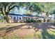 Charming brick home featuring a well-manicured lawn and beautiful mature trees at 1595 Dickens St, Charleston, SC 29407
