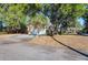 Attached two-car garage with a paved driveway and mature trees at 1595 Dickens St, Charleston, SC 29407