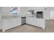 Efficient kitchen with stainless steel appliances, white cabinets, and luxury vinyl plank flooring at 1595 Dickens St, Charleston, SC 29407