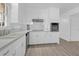 Spacious kitchen featuring white cabinets, stainless steel appliances, and modern luxury vinyl plank flooring at 1595 Dickens St, Charleston, SC 29407