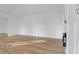 Bright living room with light hardwood floors and fresh white paint, ready for personal touches at 1595 Dickens St, Charleston, SC 29407