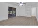 Neutral living room showcases a ceiling fan, built-in shelves, and modern flooring at 1595 Dickens St, Charleston, SC 29407