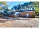 Back of the house featuring an enclosed porch and brick exterior at 1595 Dickens St, Charleston, SC 29407