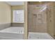 Luxurious bathroom with a tub for soaking and a large glass shower with tiled walls at 1633 Pimlico Blvd, Moncks Corner, SC 29461