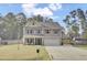 Attractive two-story home with a pristine lawn, welcoming front porch, and a convenient two-car garage at 1633 Pimlico Blvd, Moncks Corner, SC 29461