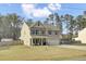 Classic two-story home with a well-maintained lawn, an inviting porch, and an attached garage at 1633 Pimlico Blvd, Moncks Corner, SC 29461