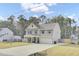 Charming two-story home featuring a well-manicured lawn, inviting front porch, and attached two-car garage at 1633 Pimlico Blvd, Moncks Corner, SC 29461