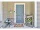 Inviting front entrance with a stylish blue door, decorative wreath, and charming 'Welcome' sign at 1633 Pimlico Blvd, Moncks Corner, SC 29461