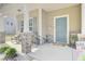 Cozy front porch with an inviting blue door, decorative planters, and comfortable seating area at 1633 Pimlico Blvd, Moncks Corner, SC 29461