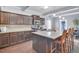 This kitchen features dark cabinetry, granite countertops, stainless steel appliances, and a large island with seating at 1633 Pimlico Blvd, Moncks Corner, SC 29461