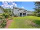 Expansive backyard featuring a covered porch, lush lawn, and mature landscaping, perfect for outdoor living at 1644 Fishbone Dr, Johns Island, SC 29455