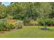 Lush, fully fenced backyard with a well-maintained lawn, mature trees, and landscaping for privacy and relaxation at 1644 Fishbone Dr, Johns Island, SC 29455