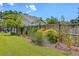 Beautiful backyard with mature trees, lush lawn, privacy fence, and manicured landscaping at 1644 Fishbone Dr, Johns Island, SC 29455