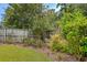 Landscaped backyard featuring a variety of plants, trees, and a wooden fence for privacy at 1644 Fishbone Dr, Johns Island, SC 29455