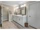The bathroom has double sinks, white cabinets, and a tile floor at 1644 Fishbone Dr, Johns Island, SC 29455
