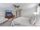 Bedroom features ceiling fan, TV, and access to an ensuite bathroom at 1644 Fishbone Dr, Johns Island, SC 29455