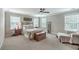 The bedroom offers three windows, ceiling fan, and a wrought iron bed frame at 1644 Fishbone Dr, Johns Island, SC 29455