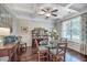 Bright dining room features coffered ceilings, hardwood floors, and a glass-topped table with seating for four at 1644 Fishbone Dr, Johns Island, SC 29455