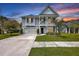 Charming two-story home featuring a welcoming front porch, well-manicured landscaping, and a spacious driveway at 1644 Fishbone Dr, Johns Island, SC 29455