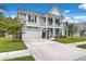Charming two-story home with a welcoming front porch, well-manicured landscaping, and a spacious driveway at 1644 Fishbone Dr, Johns Island, SC 29455