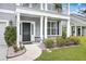 Charming two-story home with a well-maintained lawn, black front door, and inviting front porch at 1644 Fishbone Dr, Johns Island, SC 29455