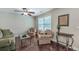 Cozy living room featuring hardwood floors, a window with blinds, and comfortable seating at 1644 Fishbone Dr, Johns Island, SC 29455