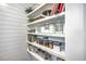 Pantry featuring white cabinets and well-organized shelves filled with various pantry staples and cookbooks at 1644 Fishbone Dr, Johns Island, SC 29455