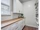 Pantry features white cabinets, butcher block countertop, subway tile backsplash, and hardwood floors at 1644 Fishbone Dr, Johns Island, SC 29455