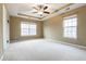 Spacious carpeted bedroom featuring a ceiling fan and two large windows at 173 Cypress Forest Dr, Moncks Corner, SC 29461