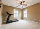 Carpeted bedroom features a treadmill, ceiling fan, and two windows at 173 Cypress Forest Dr, Moncks Corner, SC 29461