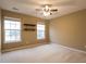 This is a spacious carpeted bedroom with two windows and shelving units at 173 Cypress Forest Dr, Moncks Corner, SC 29461