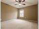 Well-lit bedroom with carpet, a ceiling fan and a large window at 173 Cypress Forest Dr, Moncks Corner, SC 29461