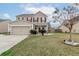 Charming two-story home with a well-maintained lawn, two-car garage, and red shutters that add curb appeal at 173 Cypress Forest Dr, Moncks Corner, SC 29461