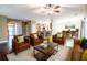 Inviting living room with hardwood floors, stylish leather seating, and an open concept to the kitchen and dining area at 173 Cypress Forest Dr, Moncks Corner, SC 29461