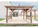 View of wood pergola with black railing overlooking wood deck, screened in porch, and fenced-in yard at 173 Cypress Forest Dr, Moncks Corner, SC 29461