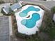 Aerial view of the uniquely shaped community pool and amenity center, surrounded by lush landscaping and a spacious parking lot at 173 Cypress Forest Dr, Moncks Corner, SC 29461