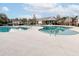 Community pool with distinct shallow areas, surrounded by a sun deck, lounge chairs, and a covered pavilion with tables at 173 Cypress Forest Dr, Moncks Corner, SC 29461