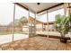 View of screened-in porch featuring wood flooring, decorative foliage, and view of outdoor deck and yard at 173 Cypress Forest Dr, Moncks Corner, SC 29461