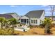 Picturesque backyard showcasing a cozy firepit area and a screened-in porch for relaxed outdoor living at 1756 Timmons St, Mount Pleasant, SC 29466